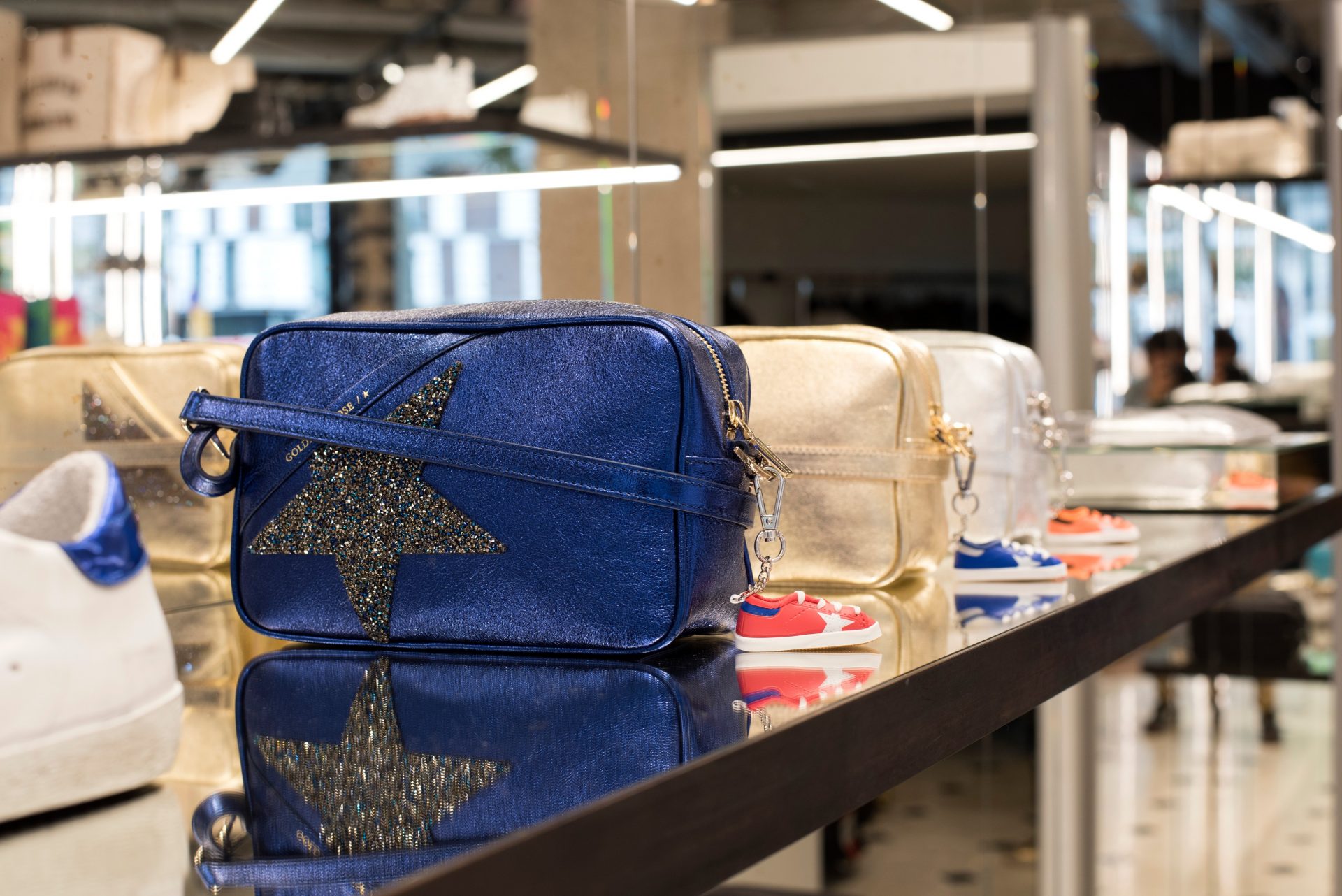 Chic and minimalist interior design at GOLDEN GOOSE, echoing the refined aesthetic of Barcelona shopping stores with carefully curated merchandise.